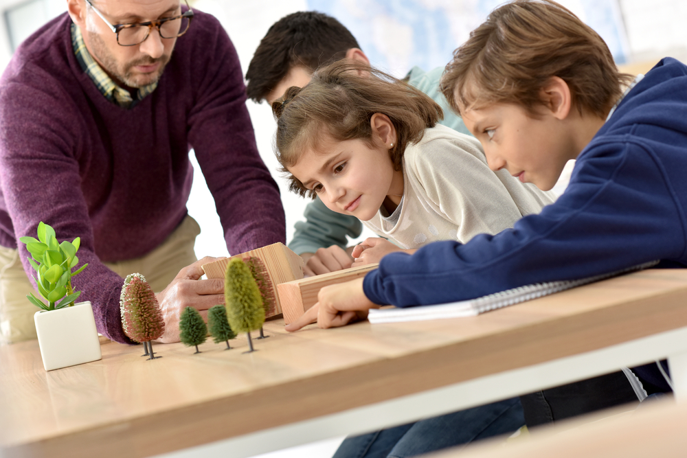 School teacher in science class with pupils